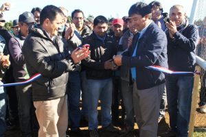 Rodrigo Avilés, Director Regional de INIA Quilamapu y el alcalde de Tirúa, Adolfo Millabur, durante el corte de cinta dando por inaugurada la estación meteorológica automática de Tirúa. Al centro observa el presidente de la comunidad Miguel Yevilao, Segundo Yevilao.
